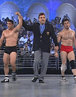 This image shows Molin officiates a made-for-television event with U.S. Olympic wrestlers.